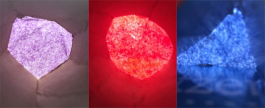 Three images with light glowing through cardboard tubes with purple, red, and blue tissue paper at the ends.