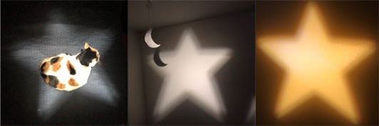 Three images: A star of light is projected onto a sitting cat and the wall.