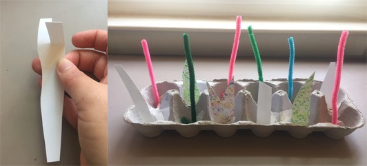Two images: Paper strip with a cut at the top to make two tabs folded in different directions. Side shot of the egg carton with pipe cleaners and paper stems standing up.
