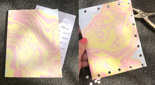 Two images: A marbled piece of paper folded in half with a handwritten note sticking out of it. A hand holds the folded piece of paper with hole punches on three edges.