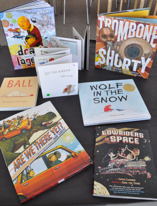 Books that have unique features include Drawn Together, Wolf in the Snow, Trombone Shorty, Ball, Out of the Window, Are We There Yet?, and Lowriders in Space.